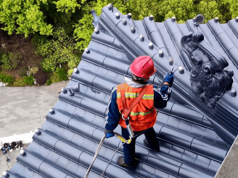 Roof inspector examining shingles on a residential roof