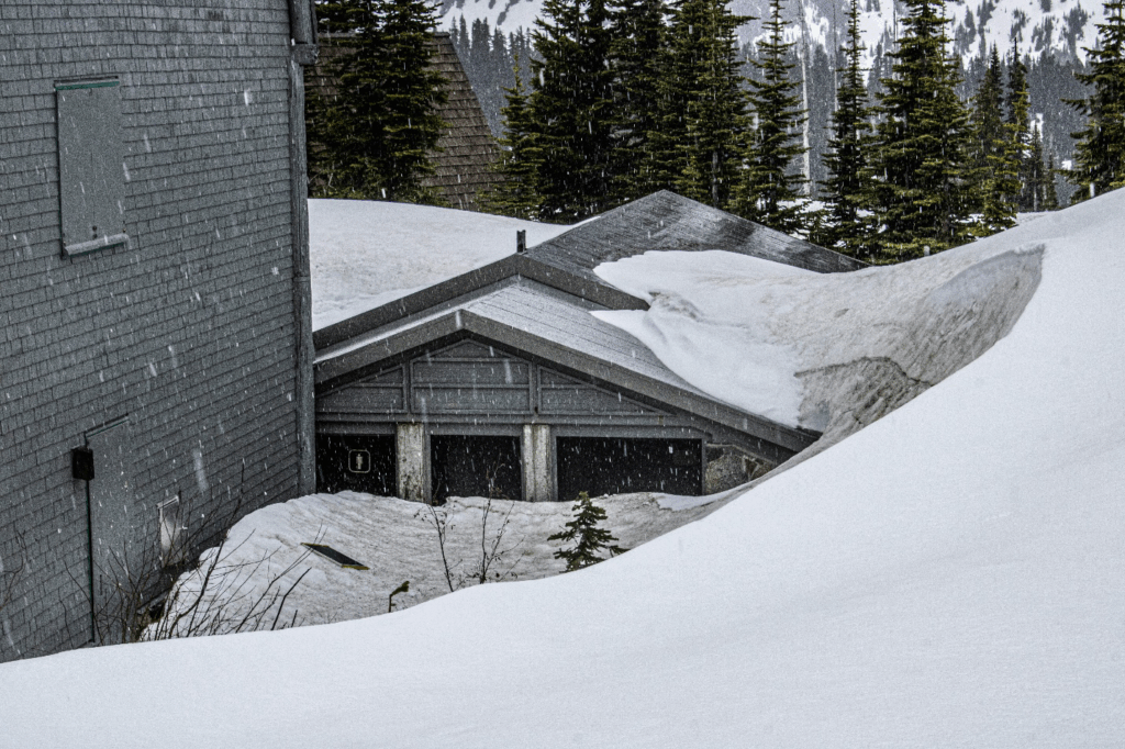 grey house roof covered by snow