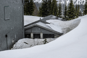 grey house roof covered by snow