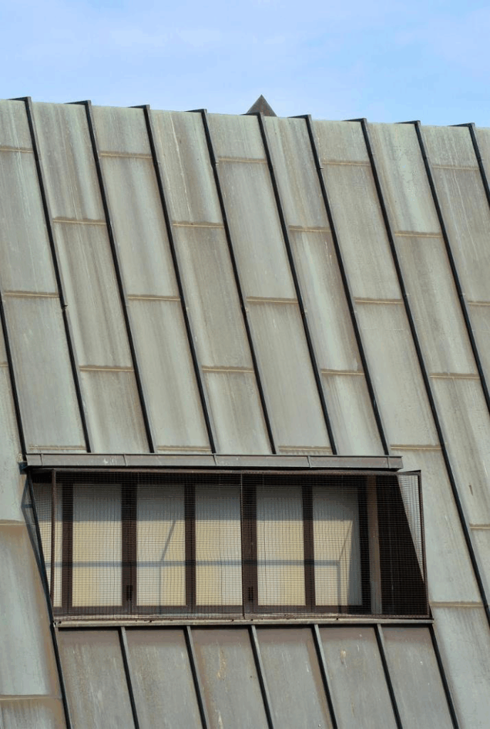 Close-up metal roofing sheets installed on a residential roof with a skylight window