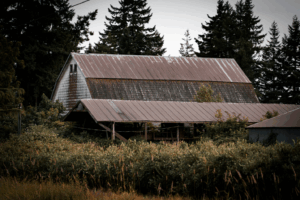 an old barn with a metal roof