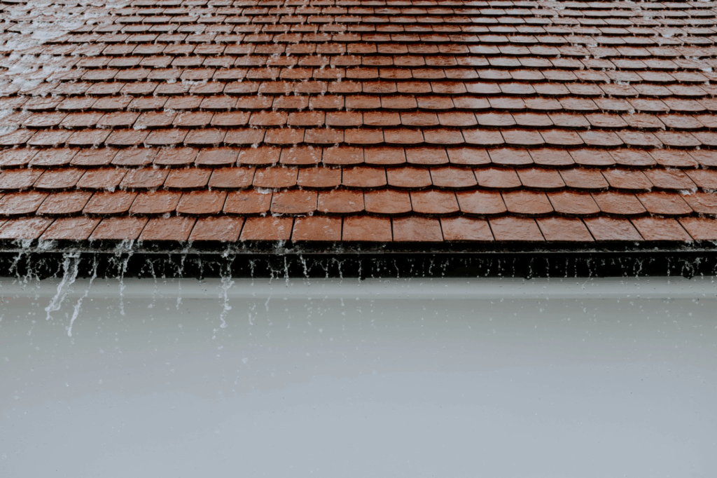 water running down from a shingle roof