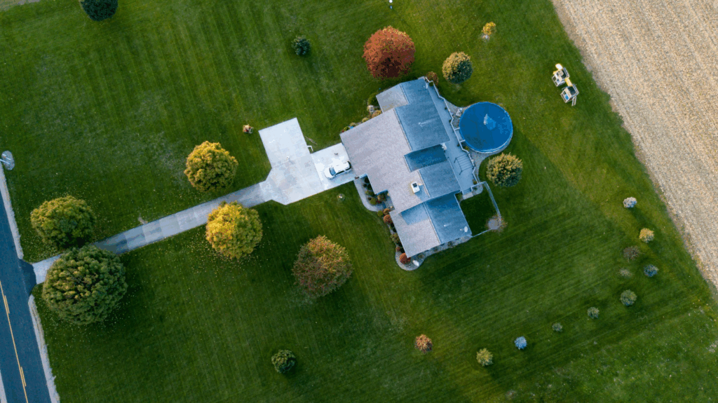 aerial view of a property and its surrounding lawn