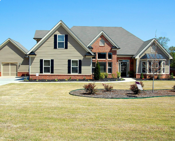 A large house with a yard and landscaping.