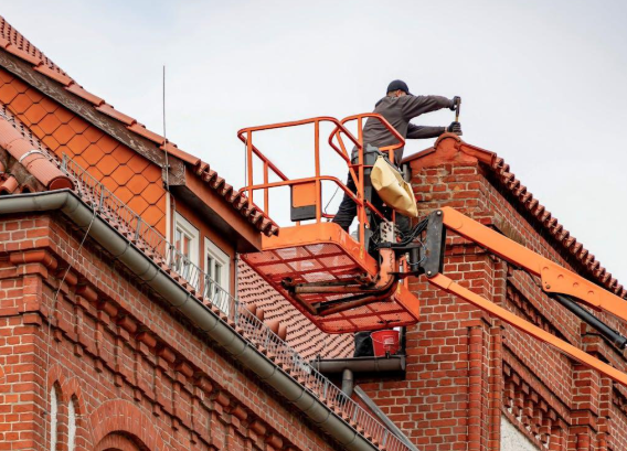A person working on roof replacement. 