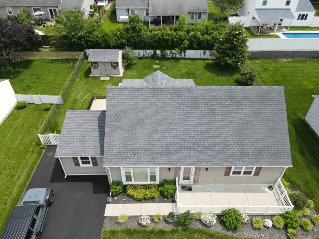 aerial view of a house with a shingle roof