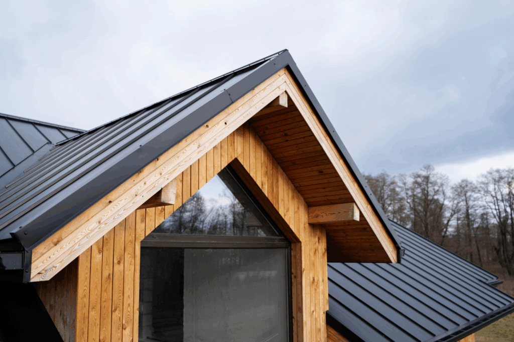 a black metal roof on top of a wooden house