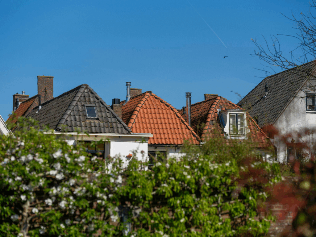 a row of houses with shingle roofs
