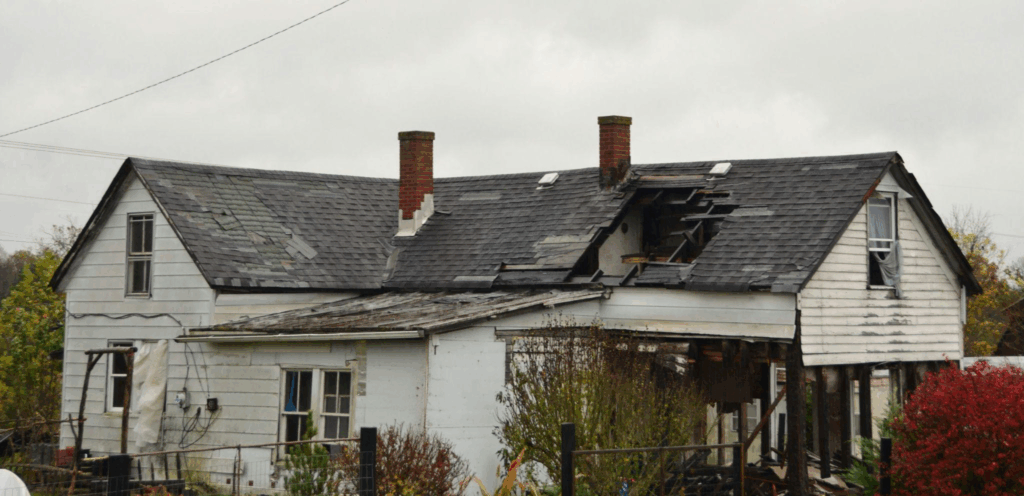 a badly damaged roof after a storm