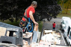 roofing contractors removing debris from a roof
