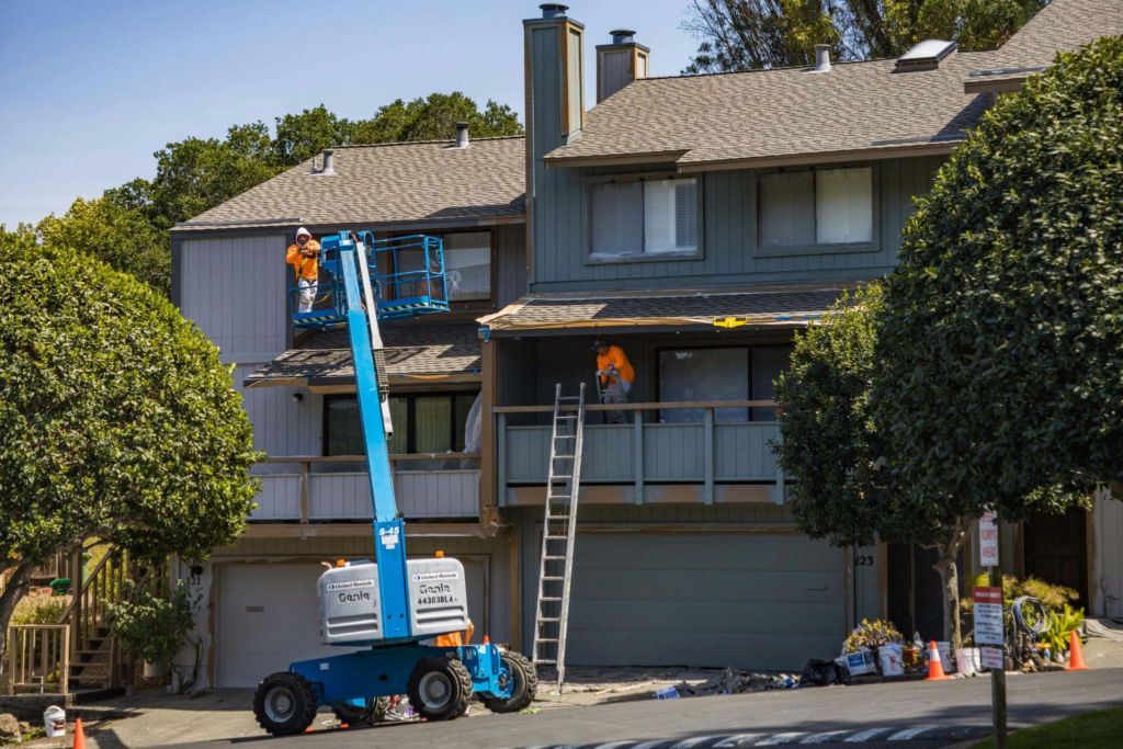 roofing contractors working on a shingle roof