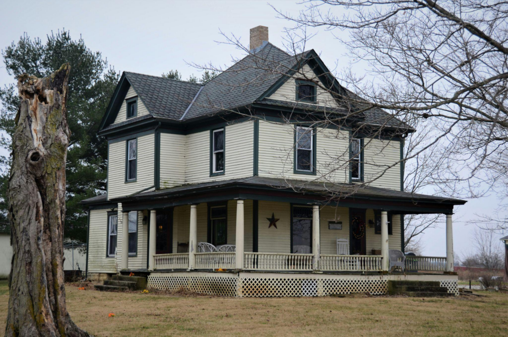 an old house with black asphalt roofing