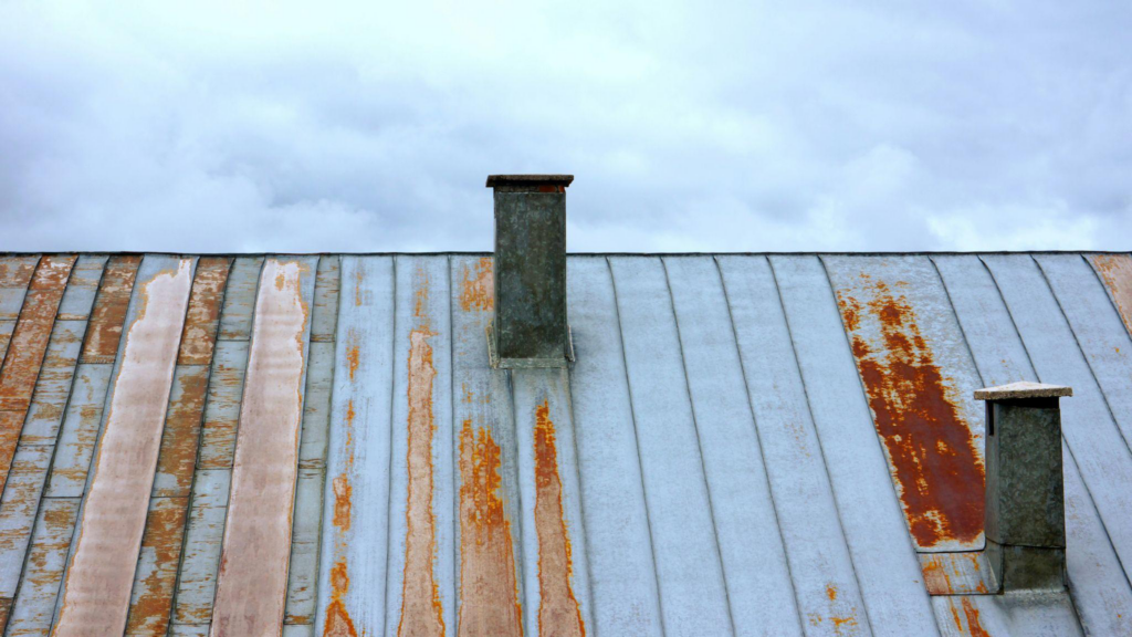 a house with a damaged metal roof