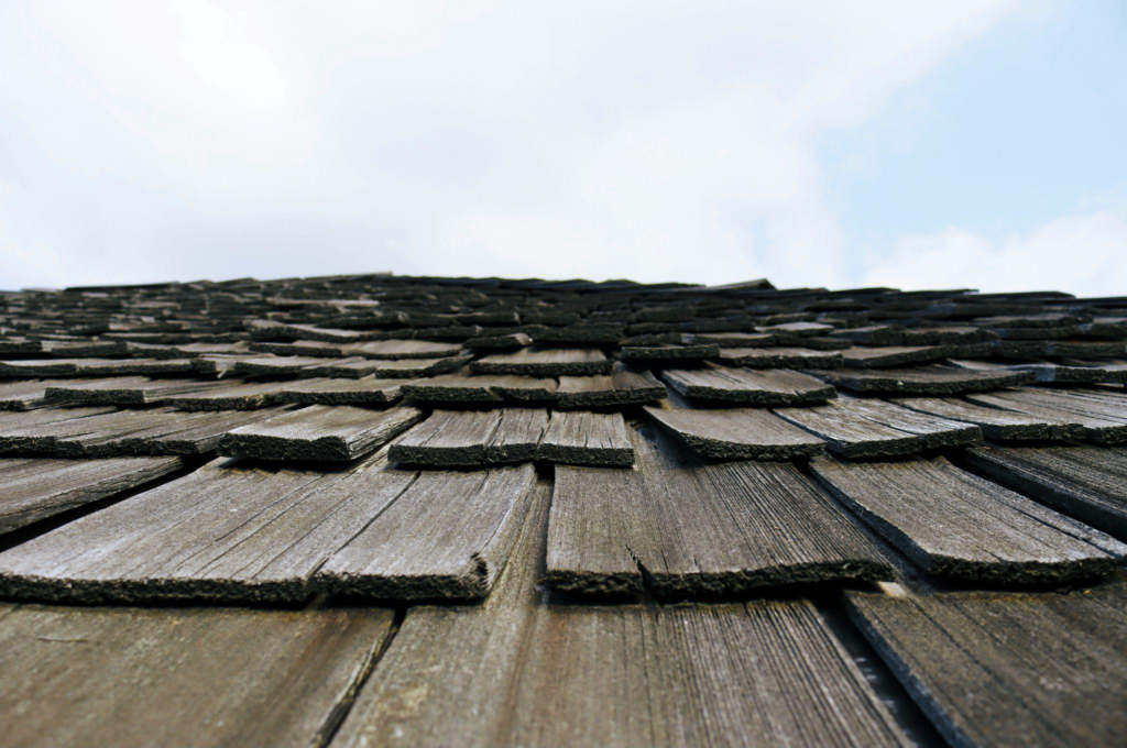 close view of old cracked shingle roofing